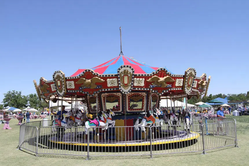 Classic carousel ride red blue striped canopy gold accents outdoor for rent in Las Vegas