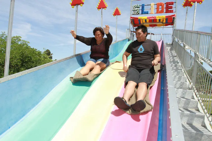 Multi colored inflatable slide adults sliding down for rent in Las Vegas