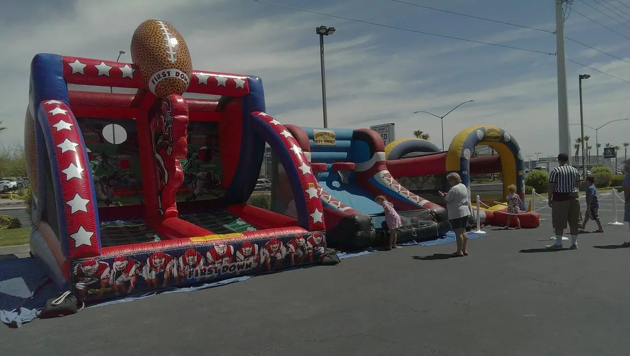 Raiders first down football inflatable obstacle course children playing for rent in Las Vegas