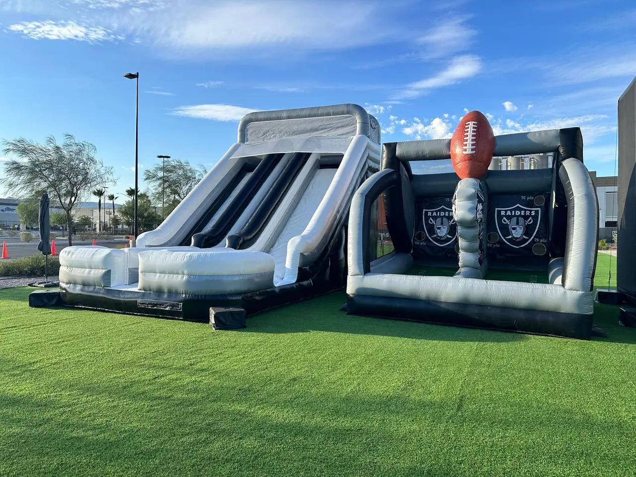Raiders football themed inflatable slide goal kick game artificial turf for rent in Las Vegas