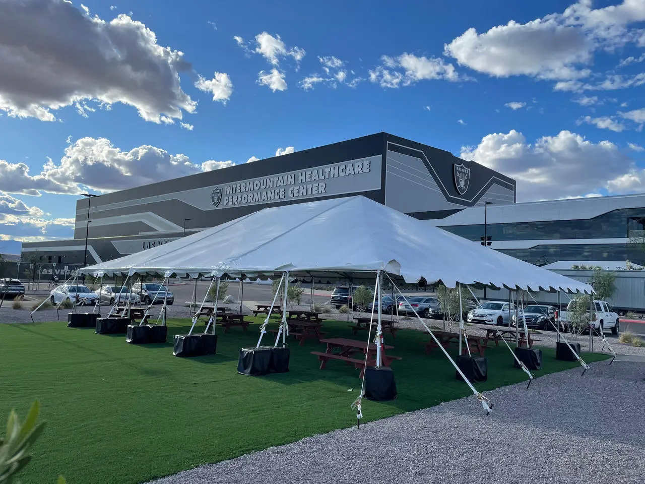 Outdoor event artificial turf white tent picnic tables raiders facility for rent in Las Vegas