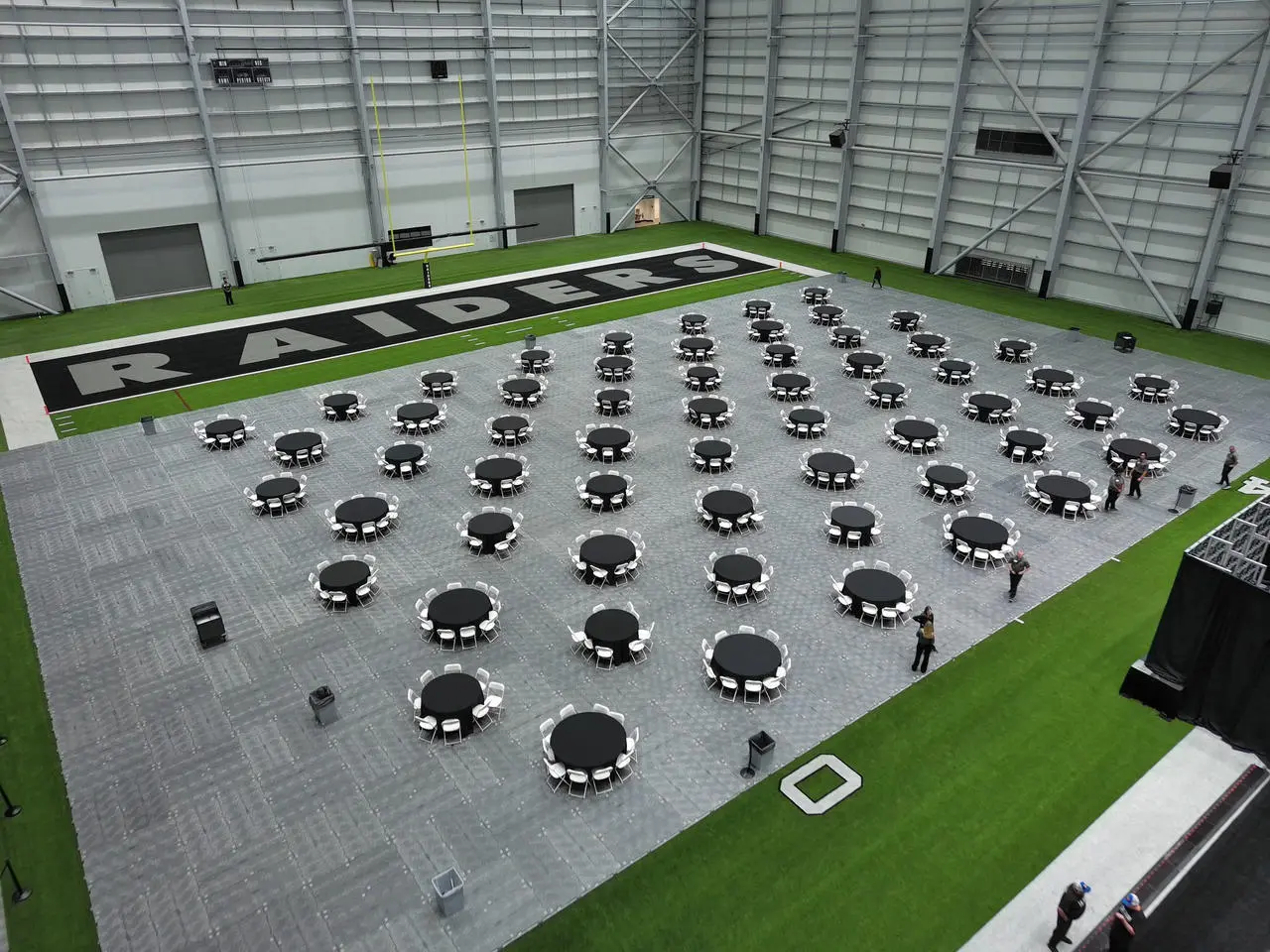 Raiders facility indoor event grey flooring tables chairs for rent in Las Vegas