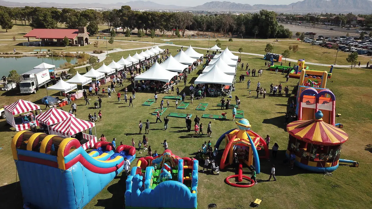 Aerial view of a company picnic with inflatables, obstacle courses and tents