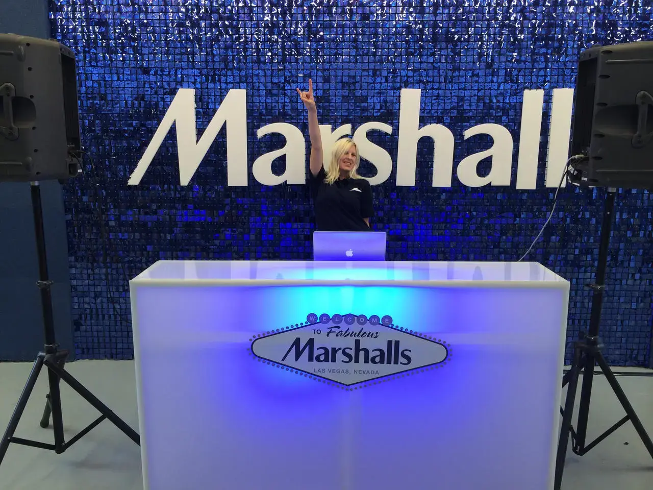 DJ performing at an illuminated booth for a Marshalls event