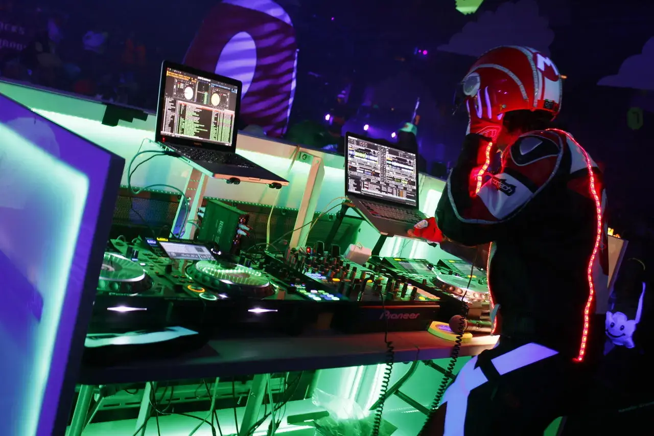 DJ in an LED suit and helmet performing at a Las Vegas event