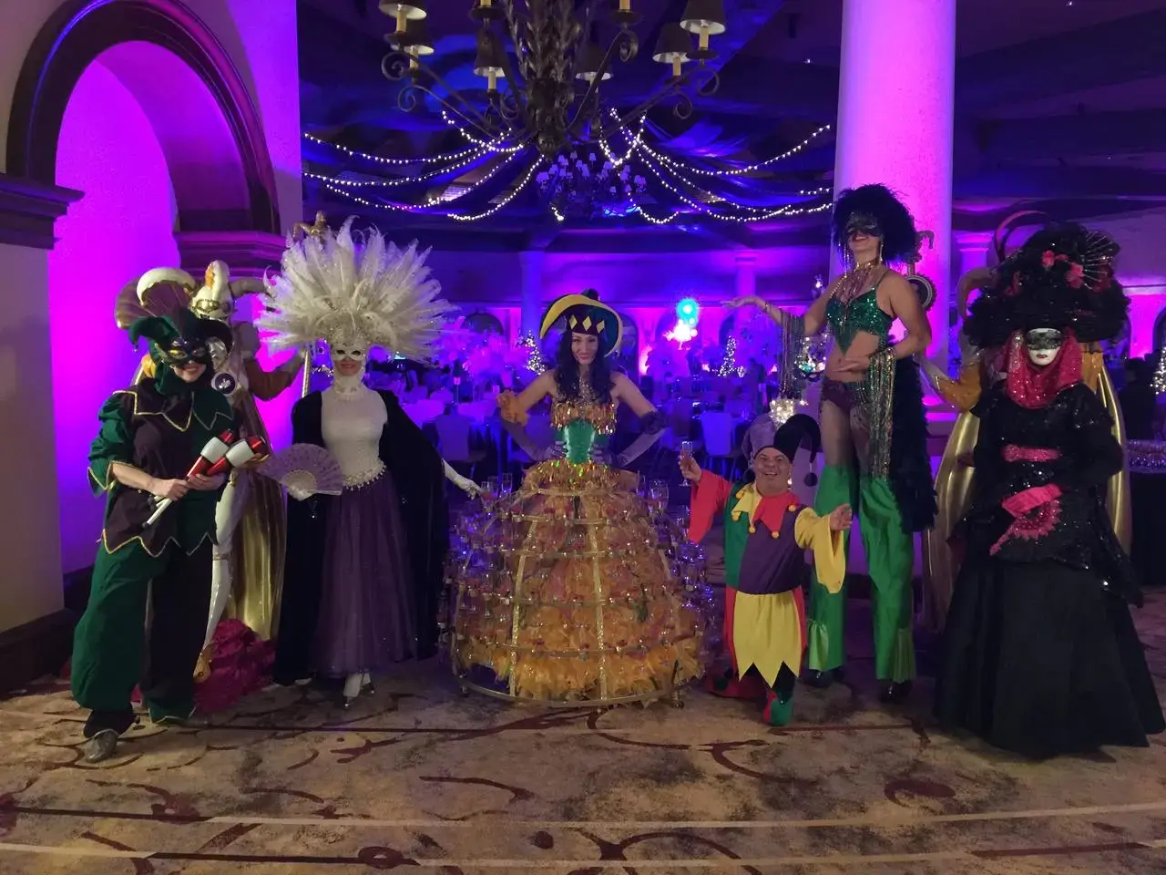 Mardi Gras masked performers and stilt walkers