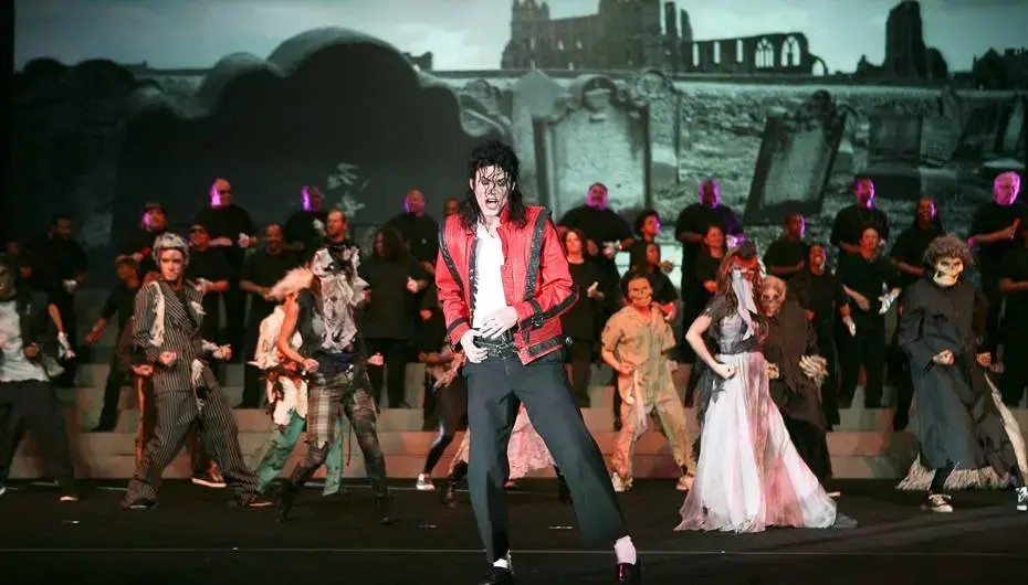 Michael Jackson tribute performer with zombie dancers on a themed stage