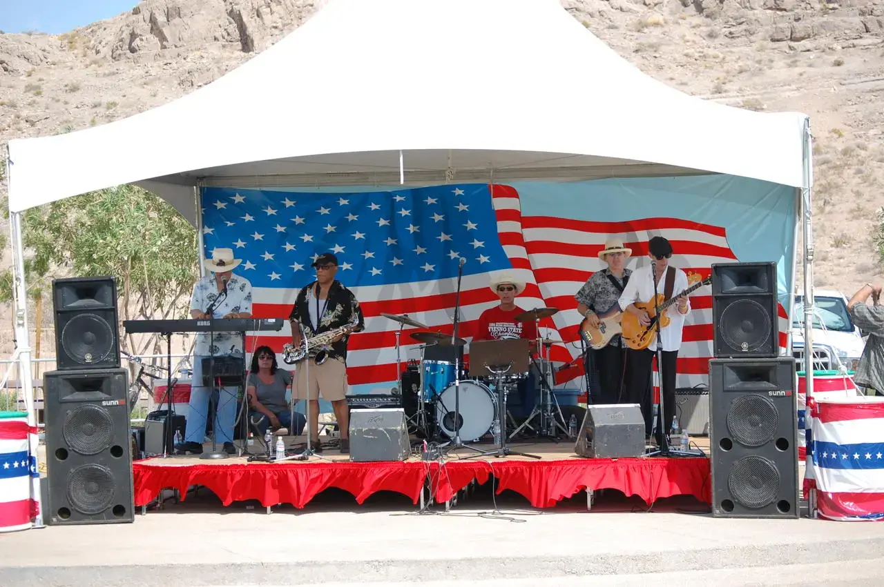 Festival band performing in front of an American flag backdrop