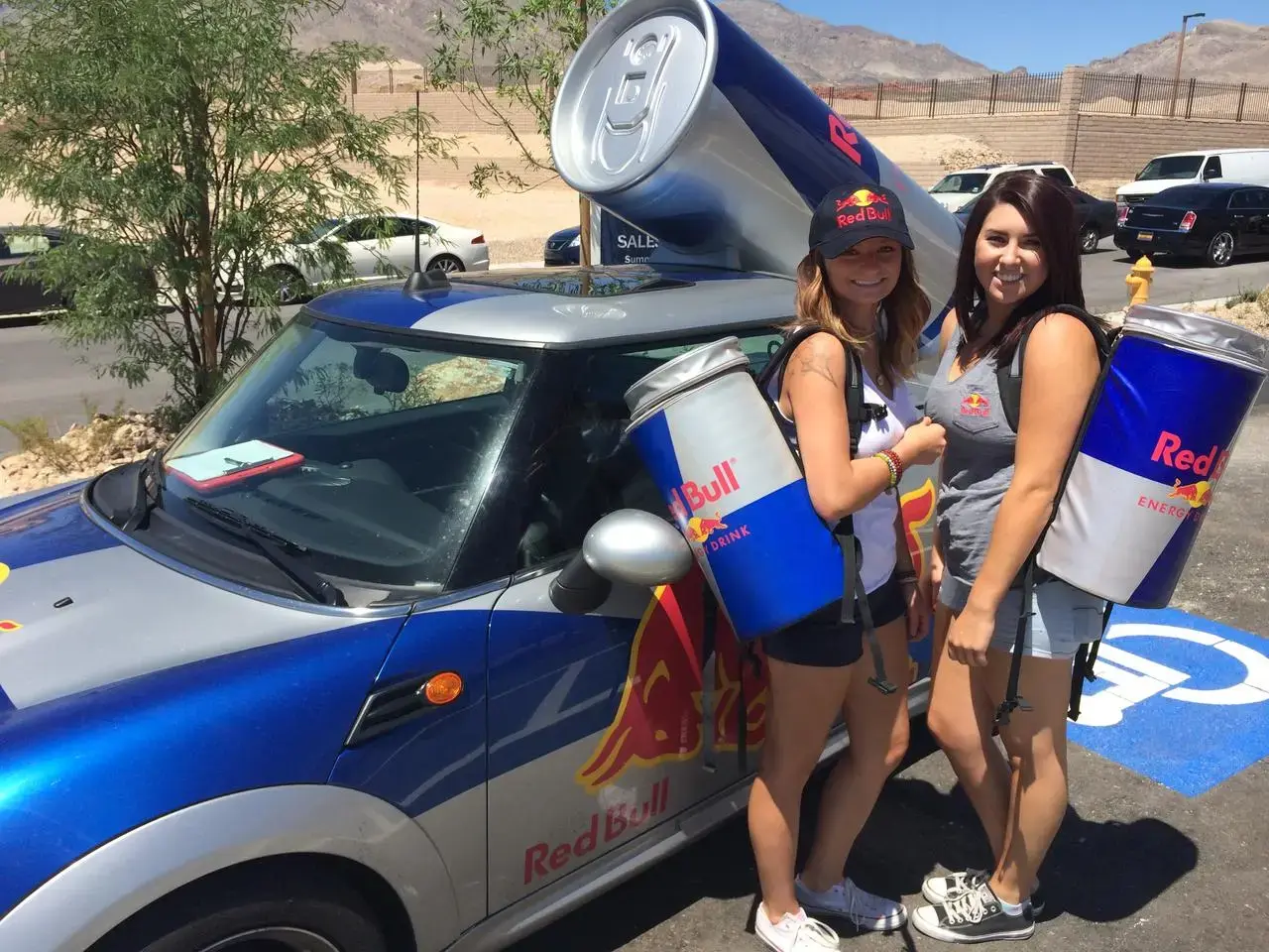 Red Bull promotional models with a branded Mini Cooper