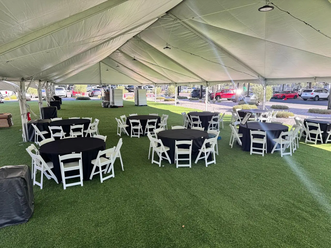Outdoor tent black tables white chairs green turf for rent in Las Vegas