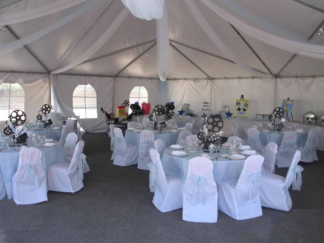 White tent blue tablecloths movie themed centerpieces for rent in Las Vegas
