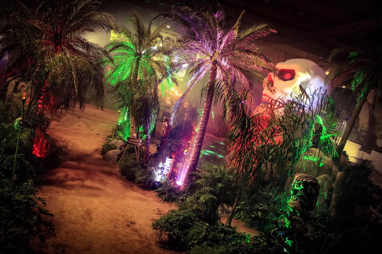 Tropical jungle themed event palm trees giant skull lighting for rent in Las Vegas