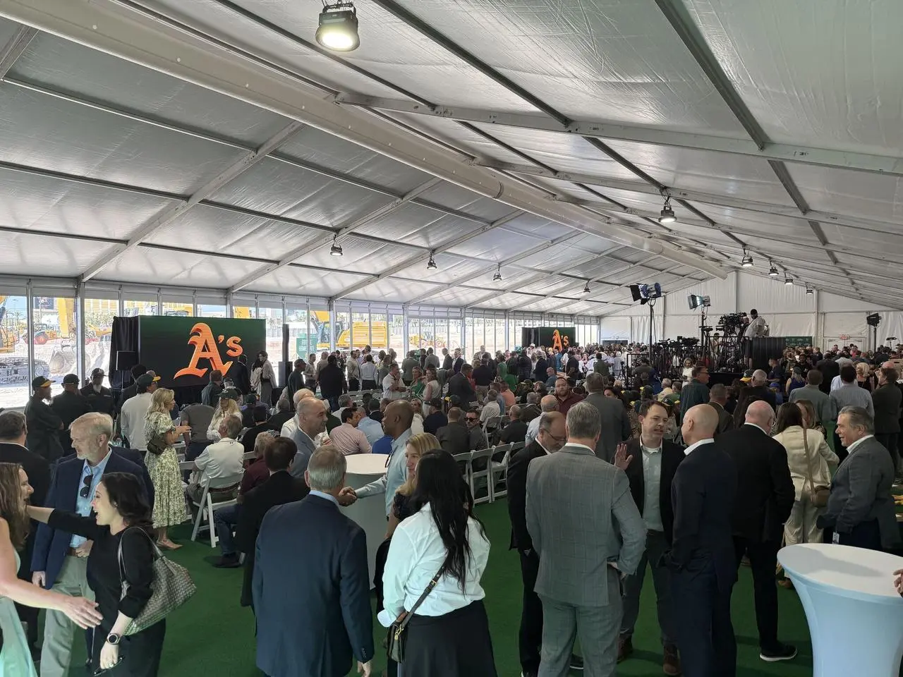 Tent interior with stage and media risers at the Athletics groundbreaking