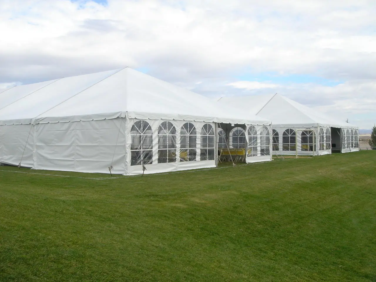 Medium clear span tent arched windows yellow tables event for rent in Las Vegas