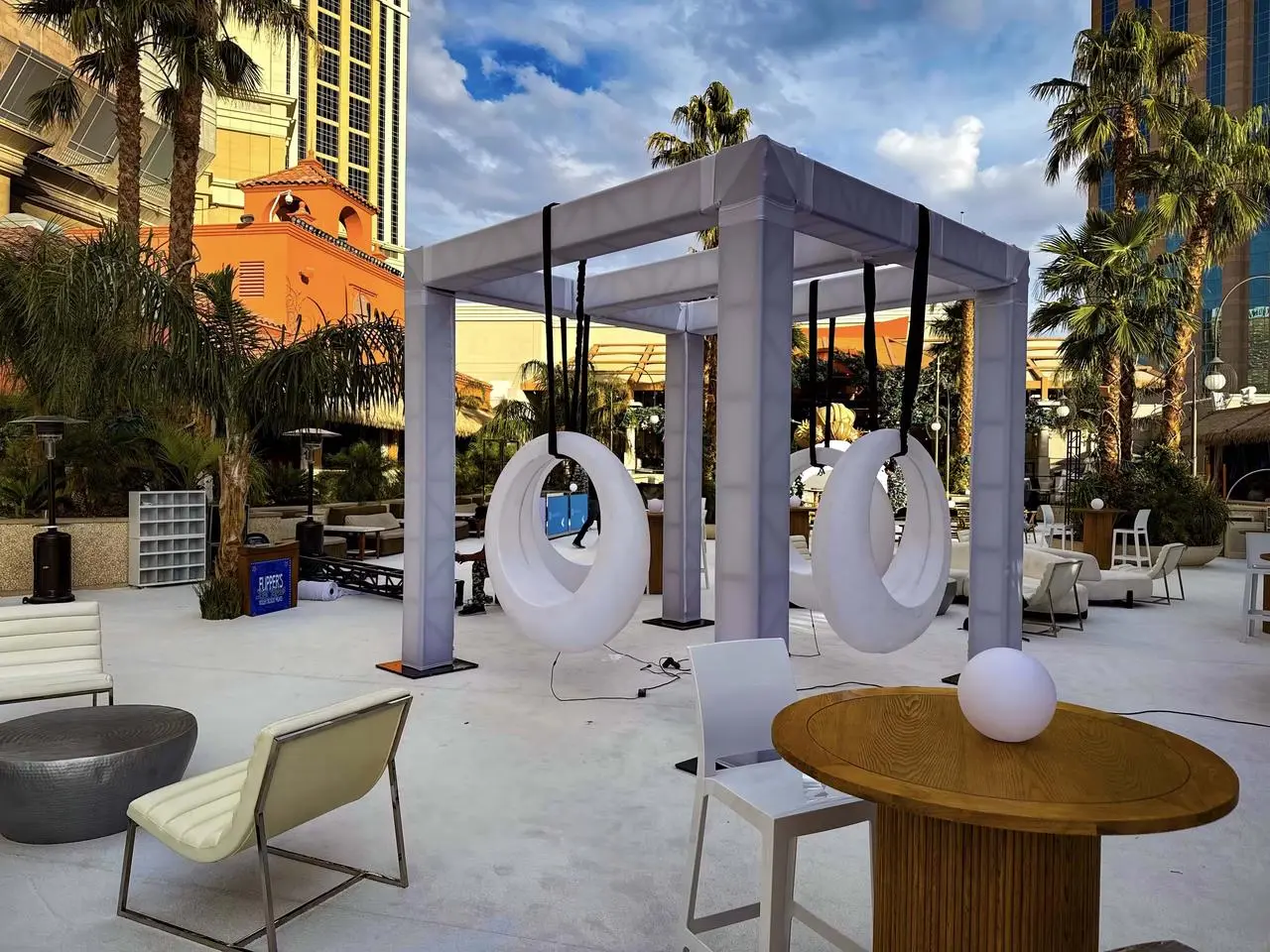 Modern outdoor lounge illuminated canopy moon swings event decor for rent in Las Vegas