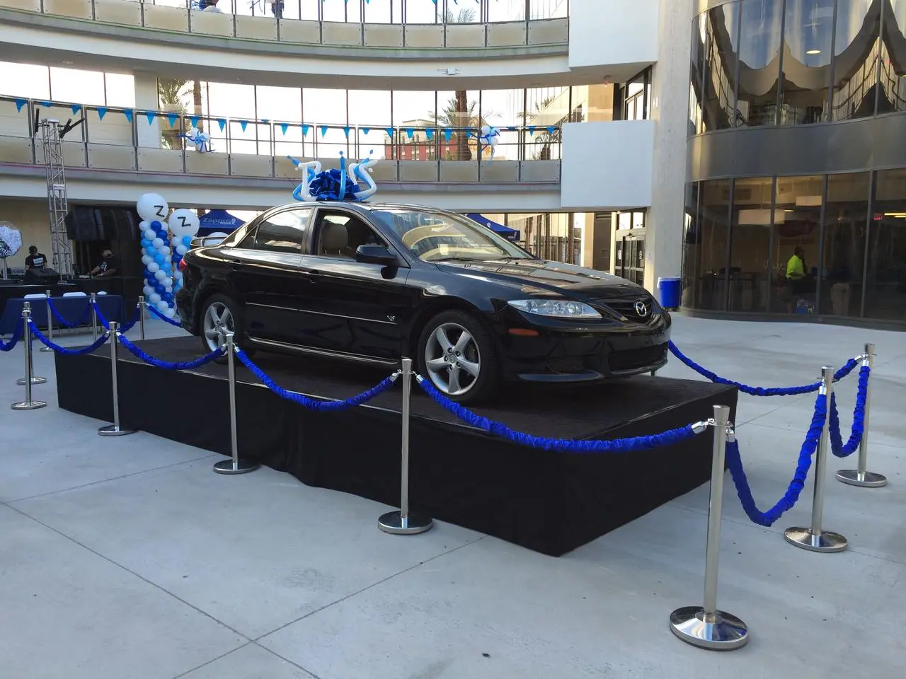 Mazda sedan car giveaway display blue bow blue white balloons event for rent in Las Vegas