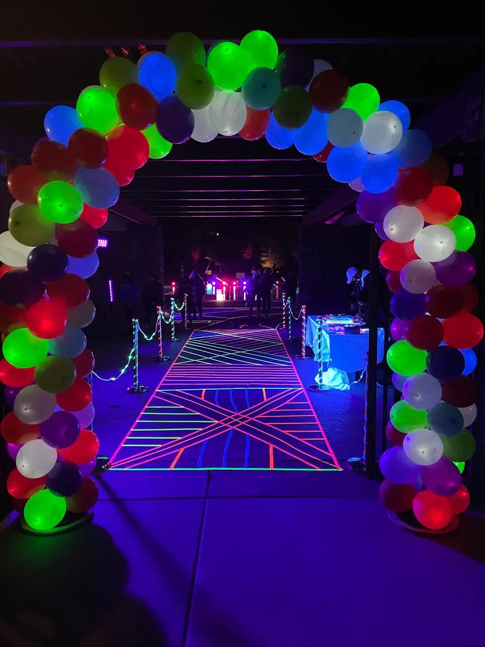 Neon balloon arch geometric pathway glow lights evening event for rent in Las Vegas