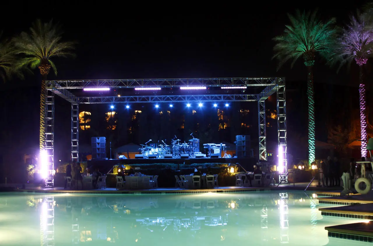 Poolside concert stage live music palm trees colored lights for rent in Las Vegas
