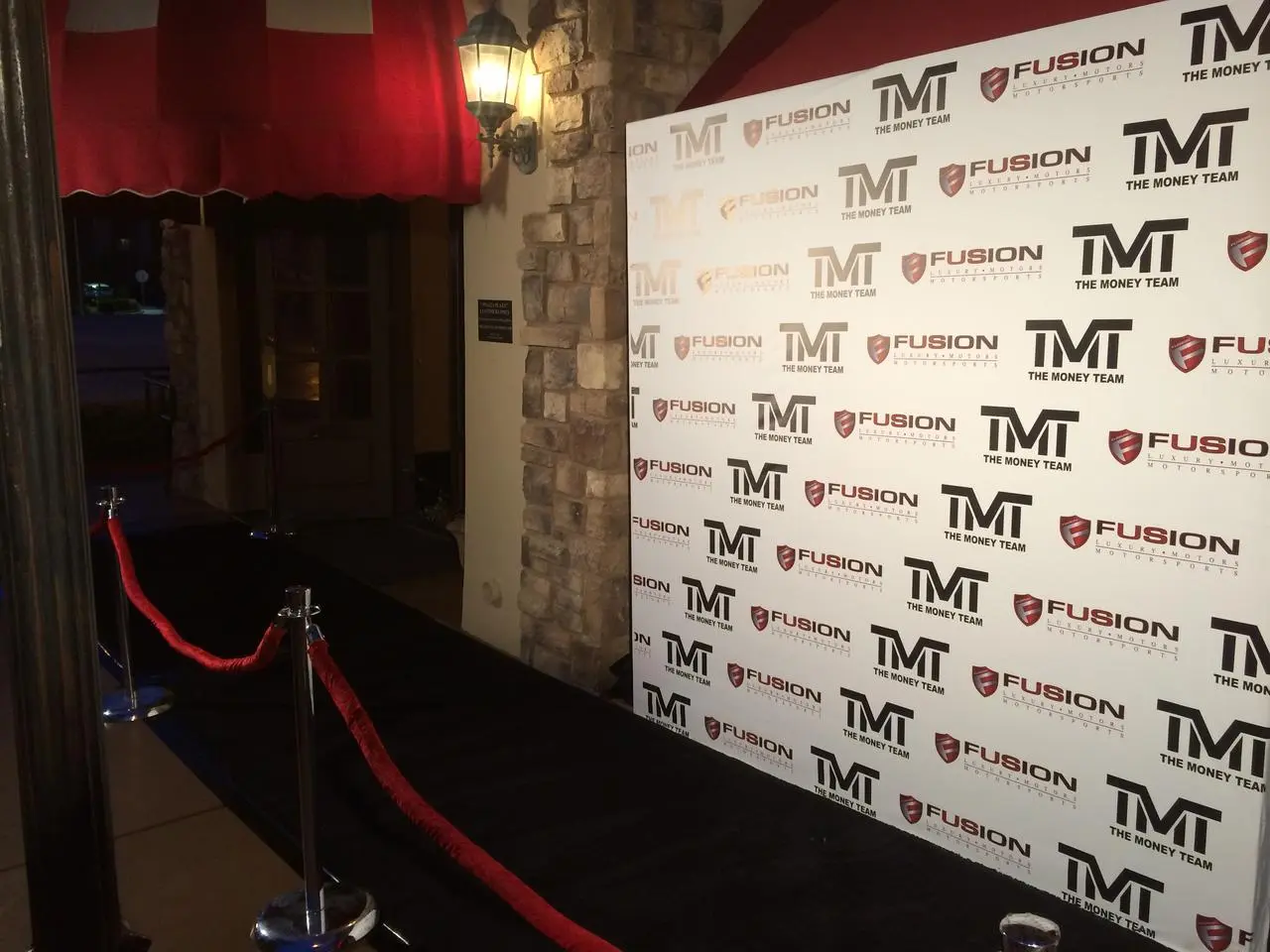 Tmt money team fusion luxury motorsports step repeat red carpet entrance for rent in Las Vegas